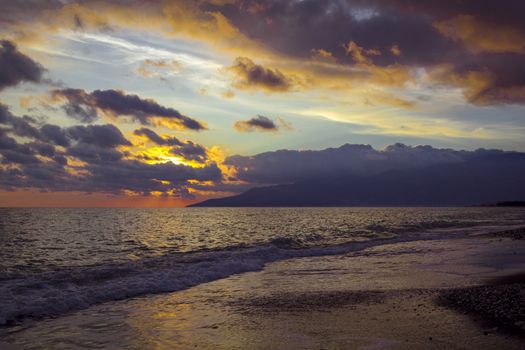 Nature in twilight period which including of sunrise over the sea and the nice beach. Summer beach with blue water and purple sky at the sunset.