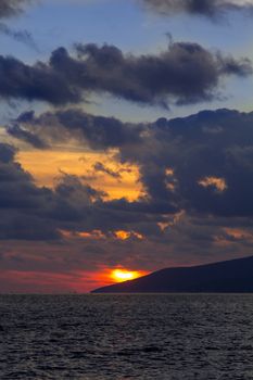 Nature in twilight period which including of sunrise over the sea and the nice beach. Summer beach with blue water and purple sky at the sunset.