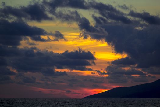 Nature in twilight period which including of sunrise over the sea and the nice beach. Summer beach with blue water and purple sky at the sunset.