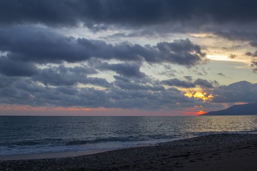 Nature in twilight period which including of sunrise over the sea and the nice beach. Summer beach with blue water and purple sky at the sunset.