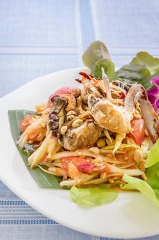 Traditional thai cuisine spicy green papaya salad with crab