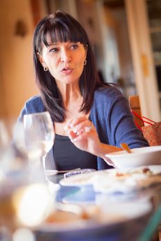 Pretty Italian Woman Enjoys A Meal And Drinks with Friends at Outdoor Restaurant.