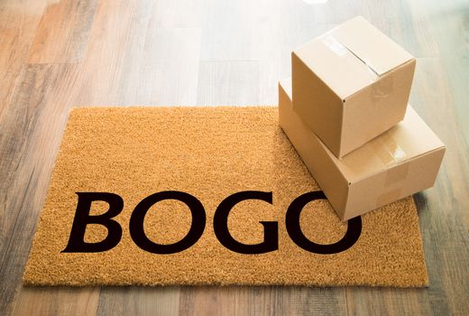 BOGO Welcome Mat On Wood Floor With Shipment of Boxes.