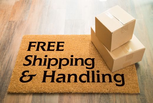 Free Shipping and Handling Welcome Mat On Wood Floor With Shipment of Boxes.