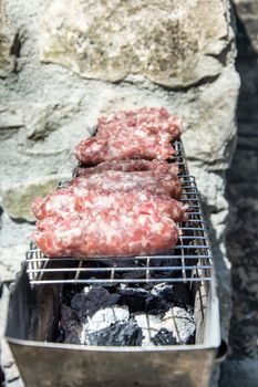 typical Abruzzo sausage grilled on fire in the woods in italy