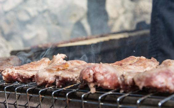 typical Abruzzo sausage grilled on fire in the woods in italy