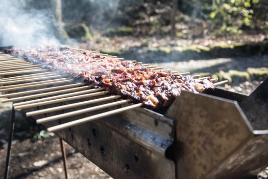 Arrosticini on the grill while turning, Abruzzi skewers of sheep cooked on the grate and on a special brazier.