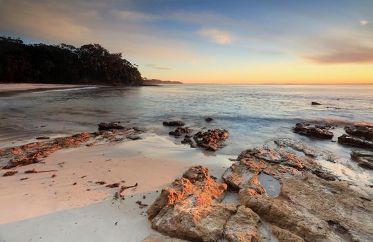 Beautiful warm golden sunlight streaming onto the beach in Jervis Bay Australia