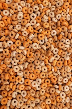 Healthy multigrain hoops breakfast cereal - wheat, barley, rice, oats and maize - as an abstract background texture