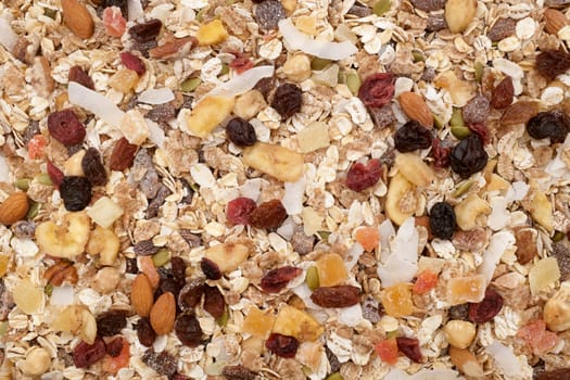 Muesli background - mixed fruit and nuts with cereal flakes and seeds as an abstract texture