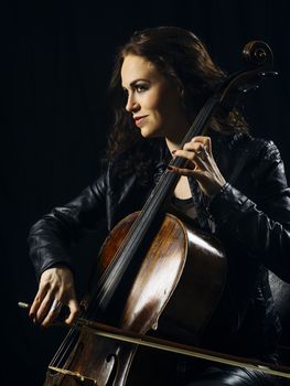 Photo of a beautiful woman playing her old cello.