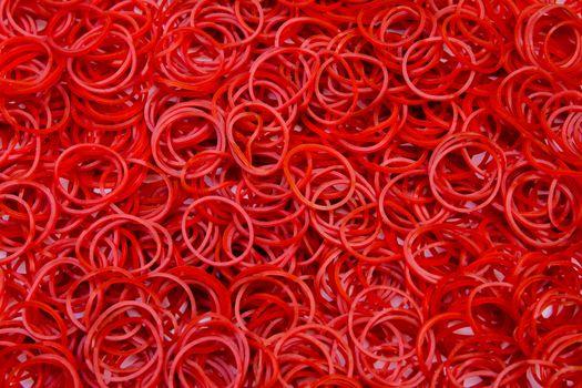 Close up red small rubber band background texture