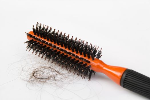 Black comb with hair loss isolated on white background