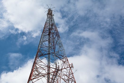 telecommunication mast TV antennas wireless technology under blue sky with cloud