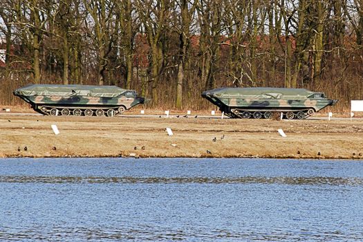 amphibious military car standing on a training ground near the river