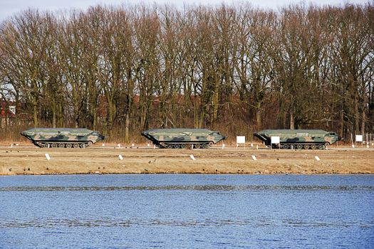 amphibious military car standing on a training ground near the river