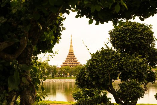 The temple reflected on the water under the sky in Thailand.