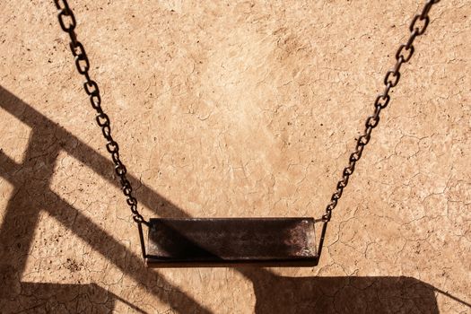 Empty chain swing in playground. Image of children swing set in park.