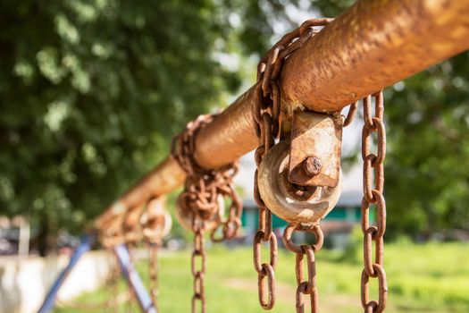 Empty chain swing in playground. Image of children swing set in park.