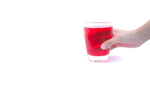 Hand holding a glass of syrup water isolated on white background