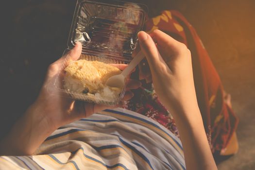 Closeup of woman's hands holding a sweets dessert. Snack of Thailand. Eating and lifestyle concept.