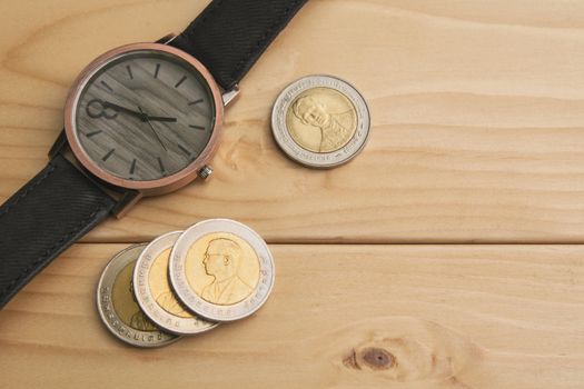 Watch with coins, time is money concept, watch with coins business and financial concept.