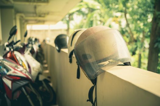 Motorcycles with Motorcycle helmets on the wall in builder. Safety concept.