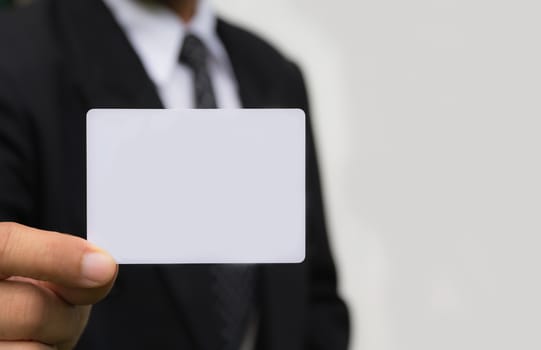 Hand of businessman holding the white card on white background.