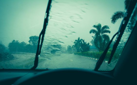 Water drop on glass mirror. Wiper on a wet windshield nature background.