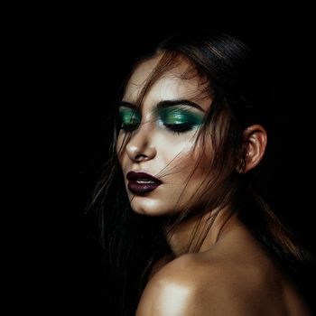 dark girl portrait with green makeup and deep red lips