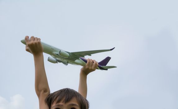 Kid playing with toy airplane. Kids playing with toy airplane at the day time. Kid having fun outdoors.