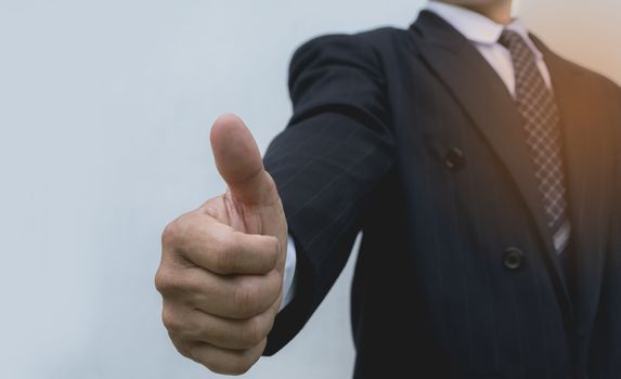 Businessman showing thumbs up making the OK gesture. business and office concept businessman showing thumbs up.