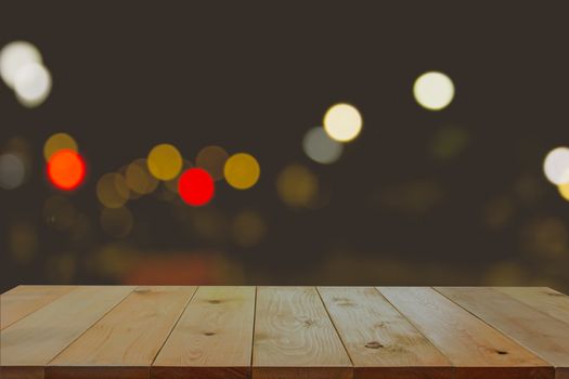 Empty wooden desk with blurred of light bokeh background.