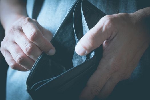 Close-up woman standing and holding the wallet empty of money