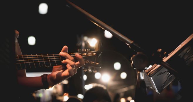 Guitarist on stage. Guitarist playing guitar, soft and blur concept.