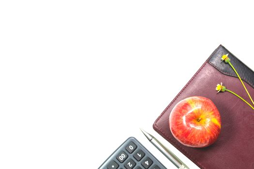 The apple with leather book, pen and calculator isolated on white background with copy space. 