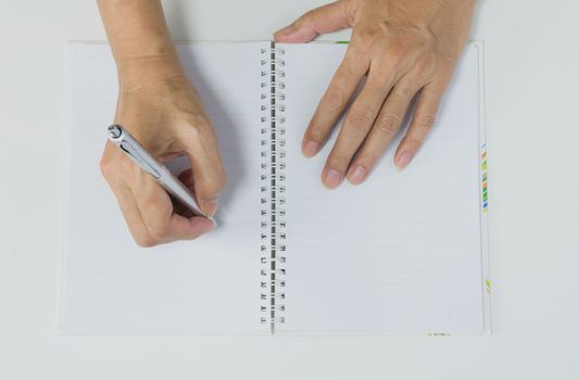 Close up hand writing on book paper with pen. Close up people writing on paper.
