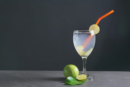 Lemonade on dark background. Lemonade with fresh lemon on table with copy space.