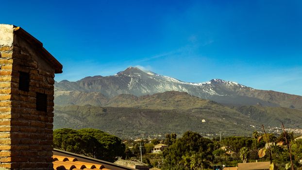 view of the Etna volcano covered by the last spring snow