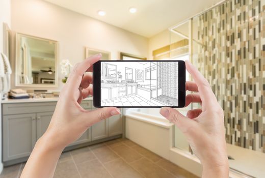 Hands Holding Smart Phone with Master Bathroom Drawing on Screen and Photo Behind.