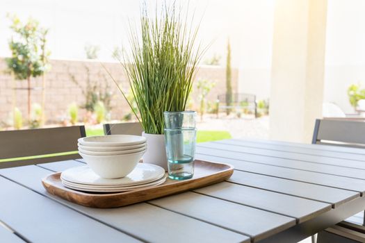 Outdoor Patio Setting with Dishes and Glasses on Tray.
