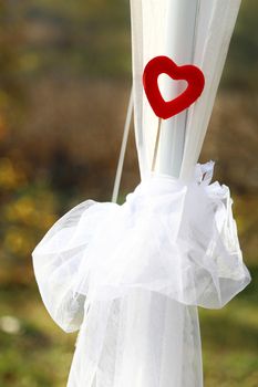 Red heart on wedding veil. Ceremony decoration