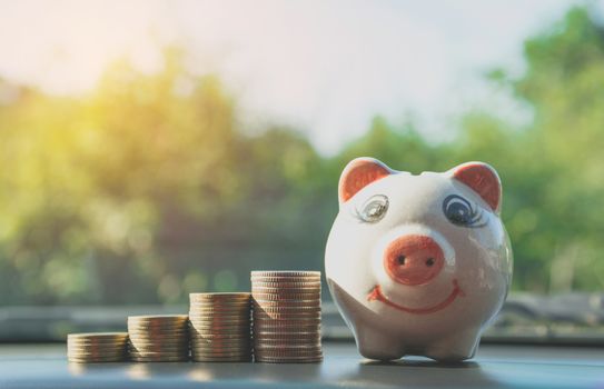Stack coins with piggy bank. Financial, accounting and saving concept.