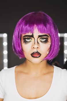 Portrait of young woman with pink hair in studio