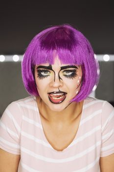 Portrait of young woman with pink hair in studio