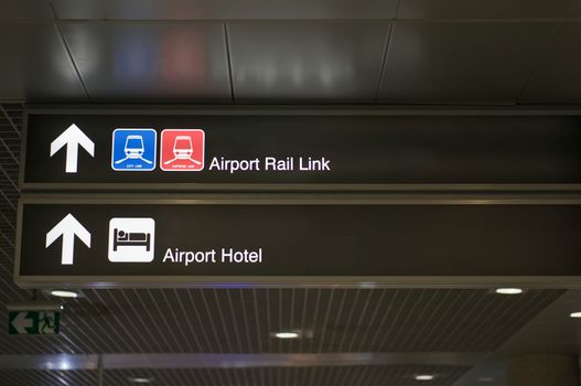 Airport rail link and airport hotel information board sign with white character on black background at international airport terminal.
