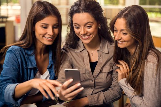 Group of girls making a pause on the studies for some gossip