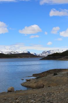 Spring arctic landscape with mountains, lake and tundra, sunny day, Mosvatn, Norway