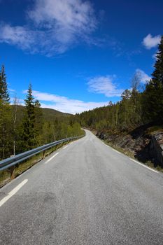 Picturesque spring Norway landscape with asphalt road