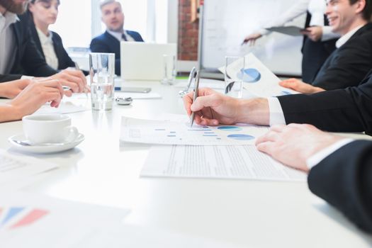 Business people at meeting in office discuss financial charts